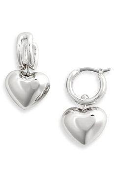 High-polished drop earrings have an innovative suspension design allowing the luminous heart to glide back and forth between the rails for subtle movement. 1/2" hoop diameter; 1" drop Snap-post closure 14k-gold plate Imported Elegant Sterling Silver Huggie Earrings With Heart Charm, Silver Elegant Huggie Earrings With Heart Charm, Elegant Silver Huggie Earrings With Heart Charm, Valentine's Day Polished Finish Earrings, Elegant Silver Huggie Heart Earrings, Elegant Double Heart Huggie Earrings With Heart Charm, Elegant Sterling Silver Heart Huggie Earrings, Elegant Heart-shaped Sterling Silver Huggie Earrings, Elegant Silver Heart Huggie Earrings