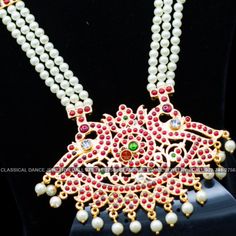 Original Design by Classical Dance Jewelry® ❥ Pearl Kempu Long Haram Chain is traditional and ethnic South Asian Indian Jewelry. ❥ 4 lines Open Peacock Style Pendant Pearls Long Necklace. ❥ You Can wear this set for Bharatnatyam Kuchipudi Dance Performances, Engagement, Weddings, Birthdays, festivals, puja, Ammavaru Amman decorations, Durgamata Decoration ❥ Handmade Indian Traditional Item. ❥❥❥ Set has variations please CHECKOUT Variants ☛ Long Necklace with earrings ☛ Long Necklace without earr Bollywood Style Temple Necklace With Peacock Design For Diwali, Bollywood Temple Necklace With Peacock Design For Diwali, Bollywood Style Temple Necklace With Peacock Design For Festivals, Bollywood Temple Necklace With Peacock Design For Festivals, Festive Temple Necklace With Peacock Design For Puja, Temple Necklace With Peacock Design For Festivals And Celebrations, Festive Puja Temple Necklace With Peacock Design, Bollywood Style Kundan Necklace With Peacock Design For Ceremonial, Festive Traditional Kundan Necklace With Peacock Design