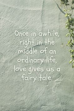 a quote written on the side of a wall next to a plant with green leaves