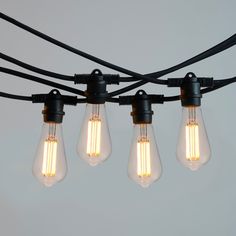 five light bulbs are hanging from a black wire