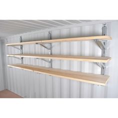 three wooden shelves on the side of a wall with metal brackets attached to each shelf