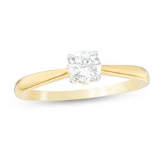 a yellow gold engagement ring with a single diamond