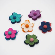 A lovely flower hair clip, hand made from merino wool, that brings a pop of colour to any hairstyle. A quirky and cute way to style your hair, our flower hair clip keep your hair secure whilst also looking great.  All of our felt products are made by one of the leading Fair Trade felt makers in Nepal. Instead of weaving the wool, felt is created by applying heat, moisture and pressure to the wool to entangle the fibres and create a beautiful end result. The felt is coloured using only natural dy Personalised Photo Albums, Felt Hair Bows, Photo Album Journal, Felt Products, Leather Photo Albums, Card Holder Purse, School Hair, Felt Garland, Flower Hair Clip