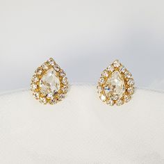 "Crystal stud earrings in a teardrop design and silver coating. These glamorous earrings are made from a high-quality NICKEL FREE silver coating, carefully handset with Swarovski crystals. The cluster design and the twinkling of the crystals, make these earrings very shiny and classy. You can choose your desired finish - yellow gold, rose gold or silver in the drop-down menu. These statement post earrings will be perfect for your wedding day and any other glam and shiny event. No matter what hai Clip-on Teardrop Earrings For Party, Teardrop Bridal Earrings With Rhinestones, Formal Teardrop Rhinestone Bridal Earrings, Formal Teardrop Bridal Earrings With Rhinestones, Formal Rhinestone Teardrop Earrings, Gold Teardrop Diamond Earrings With Sparkling Stones, White Sparkling Teardrop Earrings, Teardrop Rhinestone Earrings For Gift, Diamond White Teardrop Earrings