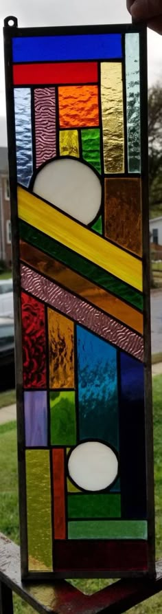 a stained glass window sitting on top of a wooden table