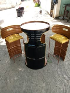 three chairs and a table sitting on the ground