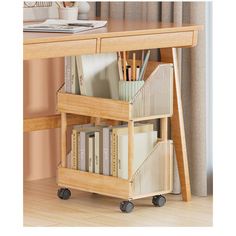 a wooden desk with some books on top of it and two drawers underneath the desk