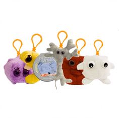 four stuffed animals are lined up in the shape of keychains, one with an eye patch on it's side