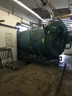 a large green tank sitting inside of a building