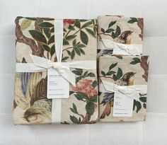 three pieces of fabric with birds and flowers on them