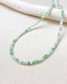 Enjoy the soft glowing colors of this chrysoprase beaded necklace. Small micro-faceted chrysoprase beads are hand-strung to create this simple yet eye-catching necklace. These petite gems display varying shades of green, creating an earthy elegance. Chrysoprase is an alternative birthstone for May. Designed as a part of our Birthstone Bar Collection, all of our birthstone charms will slip easily onto this slim necklace, allowing you to create your own unique piece. Add your birthstone or those o Faceted Jade Round Bead Necklace, Green Aventurine Beaded Hand-strung Necklace, Green Aventurine Crystal Necklaces With Round Beads, Green Onyx Necklace With Faceted Beads, Emerald Necklace With Chrysoprase Gemstone Beads, Emerald Necklace With Chrysoprase Round Beads, Handmade Chrysoprase Beaded Necklaces With Round Beads, Green Rondelle Necklace With Faceted Beads, Green Faceted Round Bead Necklaces