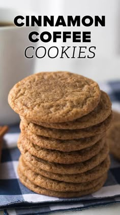 a stack of cinnamon coffee cookies next to a cup of coffee on a blue and white checkered table cloth