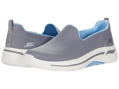 SKECHERS Performance Go Walk Arch Fit - Women's Shoes : Gray/Blue : Give your feet a relaxing atmosphere in the SKECHERS Go Walk Arch Fit Grateful sneaker. This slip-on features a soft knit mesh fabric upper and a machine washable design. Slip-on construction. Round toe with durable reinforcement and logo accent at the bumper. Rear pull-tab provides easy entry. Signature logo accents at the heel. Breathable fabric lining and lightweight, responsive ULTRA GO cushioning. OrthoLite foam insole prov Comfortable Sports Slip-ons With Arch Support, Comfortable Gray Sporty Slip-ons, Comfortable Slip-on Running Shoes With Arch Support, Functional Slip-on Sneakers With Breathable Mesh, Slip-on Running Shoes For Light Exercise, Slip-resistant Slip-on Sneakers For Light Exercise, Synthetic Low-top Slip-ons For Sports, Sporty Slip-ons With Cushioned Footbed For Sports, Gray Synthetic Slip-on Sneakers With Arch Support