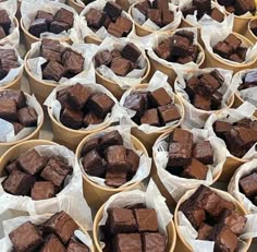 several bowls filled with brownies sitting on top of a table next to each other