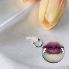 a close up of a person's lips on a white surface with a flower in the background