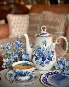 blue and white tea set with flowers on the table