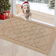 a golden retriever dog wearing a santa hat is sitting on a door mat in front of a christmas tree