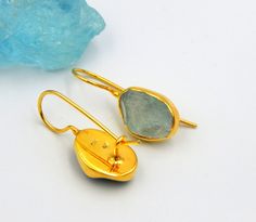 Aquamarine Rough Gemstone Earrings. Drop Earrings made out of 18 karat Gold plated Sterling Silver. 100% Handmade Jewellery with best quality stones. AQUAMARINE: Aquamarine, the birthstone of March, has a rich color and has long been a symbol of youth, health and hope. Its mesmerizing color ranges from pale to deep blue and are reminiscent of the sea. A perfect birthstone for March, the Aquamarine creates a beautiful accent to spring and summer wardrobes. THE EARRINGS: A pair of two beautifull A Oval Stone Earrings Gift, Oval Stone Earrings For Gift, Rough Gemstone Ring, Bezel Jewelry, Gemstone Drop Earrings, Aquamarine Earrings, Statement Drop Earrings, March Birthstone, Rough Gemstone