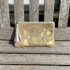 This Fleuri makeup bag / mini clutch is a great versatile little bag that is perfect for your phone, credit card and keys or to use as a stylish makeup bag. This makes a great 'grab and go' purse!  Dimensions: Height: 12cm (4.7in) Width: 20.5cm (8in) Flat construction The Fleuri clutch is made from metallic gold cowhide on both sides and has a cream, starry cotton lining on the inside. It is a flat construction, with a pretty YKK gold colour zip with a cream leather tassel pull. PLEASE NOTE; we Gold Leather Pouch For Daily Use, Chic Gold Mobile Phone Clutch, Daily Use Gold Leather Pouch, Gold Leather Clutch With Mobile Phone Bag, Gold Leather Clutch For Mobile Phone, Gold Clutch Bag For Everyday Use, Gold Rectangular Travel Pouch, Gold Zipper Pouch Cosmetic Bag For Everyday Use, Gold Clutch Mobile Phone Bag For Daily Use