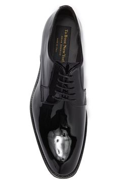 Shiny patent leather perfects this Derby style shoe with Italian crafting. 1/2" heel Lace up Plain toe Leather upper, lining and sole Made in Italy Glossy Finish Leather Dress Shoes With Round Toe, Patent Leather Oxfords With Leather Sole For Derby, Fitted Patent Leather Dress Shoes For Semi-formal Occasions, Sleek Patent Leather Dress Shoes, Sleek Fitted Patent Leather Dress Shoes, Patent Leather Closed Toe Oxfords With Rubber Sole, Classic Patent Leather Oxfords For Party, Fitted Patent Leather Pointed Toe Oxfords, Fitted Patent Leather Oxfords With Pointed Toe