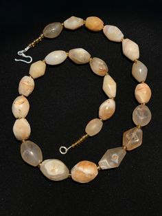 A beautiful string of Bended white agate natural found from Afghanistan dating 1800 yrs. They are found at that time in Afghanistan mostly but also some found in India and Pakistan too. They were used as a special charm jewellery by the affluents at that time period. Beautiful counter bronze are decorated further in between the beads. Artisan White Oval Beads Jewelry, White Oval Beads Artisan Jewelry, Hand-strung Round Amber Bead Jewelry, Hand-strung Amber Jewelry With Round Beads, White Polished Beads Jewelry For Healing, White Jewelry With Natural Oval Stone Beads, White Jewelry With Natural Oval Beads, Spiritual Tumbled Gemstone Beads Jewelry, White Jewelry With Oval Natural Stones