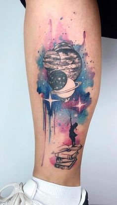 a woman's leg with a watercolor tattoo on it