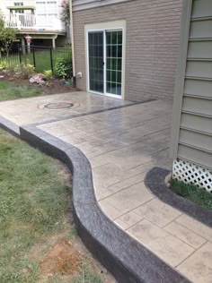 an outdoor patio with steps leading up to the back door