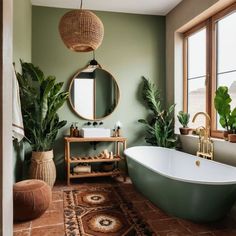 a bathroom with a tub, mirror and potted plants