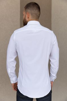 Product Description Long sleeve, button-down, white trim fit shirt. This best selling Leeward style features performance fabric that will make this a go to in your wardrobe. Details & Fit Recommend ordering true to size Front Body Length: 29.5" (Measured from Large) Performance fabric dress shirt Superior quick-dry properties Wrinkle resistant Spread collar Back darts Long sleeves Convertible cuffs Curved hem Materials & Care 85% Polyester 15% Spandex Machine Wash Cold Modern White Long Sleeve Dress Shirt, White Shirt With Button Cuffs And Lapel Collar, White Long Sleeve Shirt For Business Casual, Fitted White Top With Button Cuffs, White Collared Dress Shirt With Button Cuffs, Tailored White Long Sleeve Tops, Fitted White Dress Shirt With Buttons, White Fitted Dress Shirt With Buttons, Fitted White Tops With Placket