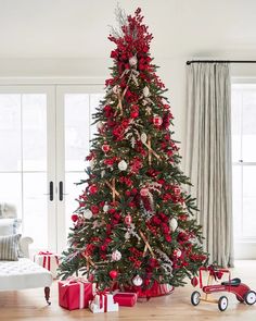 a decorated christmas tree with red and silver ornaments