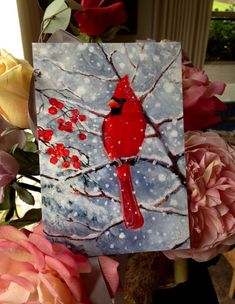 a painting of a cardinal sitting on a tree branch in front of pink flowers and roses