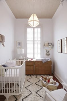 a baby's room with a crib, dresser and bed