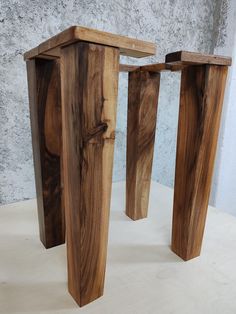 two wooden stools sitting next to each other