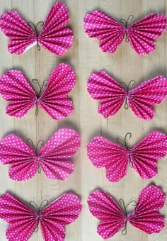 several pink butterflies with white polka dots on them are arranged in the shape of hearts