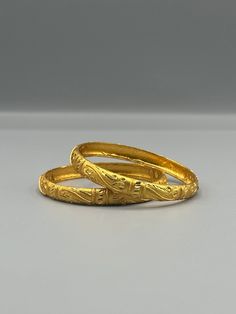 Our 24k Polished Bangles are more than just accessories; they are symbols of grace and beauty, inspired by the rich heritage of Indian, Pakistani, and Nepali jewelry. These stunning bangles showcase the timeless elegance of traditional craftsmanship, perfectly complementing your attire for weddings, festivals, or any special occasion Our company offers expedited Next-Day Delivery Services within the United Kingdom, ensuring prompt and efficient transportation of goods.  Additionally, we strive to extend our shipping capabilities to cater to customers worldwide, aiming to provide the fastest possible shipping methods to international destinations. To ensure the highest standards of hygiene, we kindly request your understanding that all sales are final, and we are unable to accept returns or Elegant Etched Bangle For Wedding, Gold Etched Bracelet Jewelry, Traditional Gold Bracelet For Anniversary And Festivals, Gold Temple Jewelry Bangle For Anniversary, Traditional Yellow Gold Bangle With Intricate Design, Gold Etched Bracelet For Wedding, Vintage 22k Gold Engraved Jewelry, Ceremonial Temple Jewelry Gold Bracelet, Temple Jewelry Gold Bracelet With Intricate Design