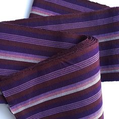 purple and red striped tie laying on top of each other