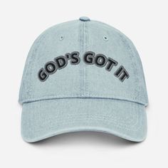 a light blue hat with the words god's got it embroidered on the front