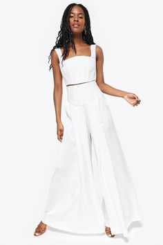 These flowy pants feature a wide leg silhouette and a fitted, corset waist detail. Additionally, these pants boast pockets, a high waisted fit, and a pleat detail from corseted waist. Look Wide Leg, Fitted Corset, Colour Representation, Photography Places, Corset Waist, White Trousers, Flowy Pants, Product Shots, Corset Style