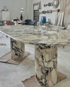 a large marble table sitting inside of a room