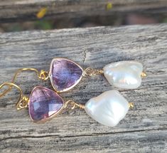 These elegant gold amethyst faceted crystals and  big baroque pearls earrings are  great for everyday use, parties, or for special occasions! It is made with big genuine baroque pearls, wire wrapped in gold filled wires, measures 9mm to 12 mm x 15mm to 17mm (big baroque, light). The color is natural white, pearls are lustrous. The pearl is attached to a amethyst purple glass connector bezel gold rhodium plated connector.  Material: Genuine Baroque Pearls, lustrous, wrinkled Size: 9mm to 12 mm x 15mm to 17mm Finding: gold plated ; amethyst  purple glass bezel connector. Length ( with ear hooks) is around 2 inches (  50 mm ). Note: Your jewelry will arrive beautifully and carefully packaged in a gift box with a pretty ribbon. Gold Amethyst Earrings For Parties, Elegant Gold Amethyst Crystal Earrings, Handmade Amethyst Wedding Earrings, Elegant Amethyst Earrings As A Gift, Handmade Amethyst Earrings For Wedding, Gold Amethyst Drop Earrings, Wedding Amethyst Earrings With Natural Stones, Handmade Elegant Amethyst Crystal Earrings, Gold Amethyst Crystal Earrings