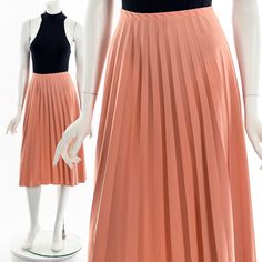 "- 60s/70s peach pleated skirt - elastic waist - knee length Fits like:  M - L Material:  Polyester Condition:  Great Clipped on Mannequin: Yes ✂ SIZE + FIT ✂ Length: 29\" / 74 cm Waist: 28\" to 34\" / 71 cm to 86 cm Hips: 46\" / 117 cm All measurements are taken with garment lying flat. ALWAYS refer to measurements as vintage sizes can vary greatly from today's modern sizes. We recommend comparing measurements above with a similar style garment you own for best fit before purchasing.  DRESS FORM / MANNEQUIN is wearing the size detailed above but she typically measures a size 4/6 by modern retail sizes or a general size small. Belt Accessories and other clothes are NOT included. ▲▲All Garments Have Been Laundered/Steamed or Dry Cleaned and are Ready-To-Wear▲▲ Are you interested in purchasi Orange Pleated Party Skirt, Orange Pleated Skirt For Spring, Orange Pleated Skirt For Party, Spring Orange Pleated Skirt, Vintage Knee-length Pleated Spring Skirt, Chic Fitted Peach Skirt, Peach Skirt, Dress Form Mannequin, Small Belt