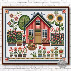 a cross stitch pattern on a brick wall with flowers and potted plants in front