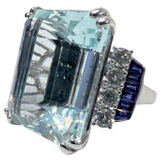 18K white gold ring with 30.93 carat aquamarine, 0.68 carat diamond and 0.69 carat sapphire. Sophia D by Joseph Dardashti LTD has been known worldwide for 35 years and are inspired by classic Art Deco design that merges with modern manufacturing techniques. Aquamarine Brilliant Cut Diamond Ring For Formal Occasions, Formal Aquamarine Diamond Ring With Brilliant Cut, Luxury Gia Certified Aquamarine Ring, Luxury Diamond White Topaz Ring For Formal Occasions, Blue Gia Certified Emerald Ring For Formal Occasions, Formal Aquamarine Diamond Ring With Prong Setting, Formal Diamond White Blue Topaz Ring, Formal Blue Topaz Diamond Ring In Diamond White, Formal Aquamarine Diamond Ring With Gemstone