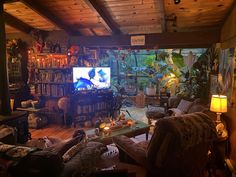 a living room filled with lots of furniture and a flat screen tv mounted to the wall