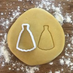 a cookie that has been shaped to look like a dress and a bottle on it