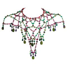 Dramatic bohemian capelet necklace from the 1960's USA. Handmade and composed of multicolored imported glass, resin beads and Swarovski crystal balls which form a capelet over shoulders. Wonderful colorations, perfect over a simple gown. 1960's USA. Neck Length 14 .25", plus necklace extender 2 7/8 " Center Front 11", Center Back 9" Bohemian Bead Caps Necklace For Party, Bohemian Beaded Evening Necklaces, Multicolor Necklaces With Bead Caps For Party, Simple Gown, Jewel Top, Shoulder Jewelry, Vintage Beads Necklace, Crystal Balls, Necklace Extender