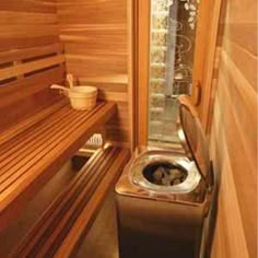 the inside of a sauna with wooden walls and flooring, including a bench