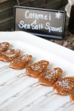 caramel sea salt spoons are lined up on a white platter, ready to be served