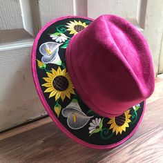 Stand out with this beautiful handcrafted Mexican Suede Hat with beautiful detailed floral embroidered canvas brim. Perfect accessory to add that with that daily outfit. MADE IN MEXICO By: Mexican Artisans For: Women Size: Medium 23' Color: magenta | multi Details: Top Suede Embroidered canvas brim Inner elastic band Contact us for more details PLEASE READ BEFORE PURCHASE: The picture is an ACCURATE REPRESENTATION.Colors in the pictures may vary a little by effects of light. Each product is hand Adjustable Embroidered Sun Hat With Flat Brim, Adjustable Embroidered Flat Brim Sun Hat, Traditional Felt Hat With Adjustable Curved Brim, Traditional Adjustable Felt Hat With Curved Brim, Traditional Adjustable Brimmed Felt Hat, Embroidered Adjustable Sun Hat With Curved Brim, Embroidered Sun Hat With Adjustable Curved Brim, Adjustable Embroidered Sun Hat With Curved Brim, Bohemian Embroidered Fedora Hat