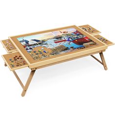 a wooden table with two trays on it and an image of boats in the water